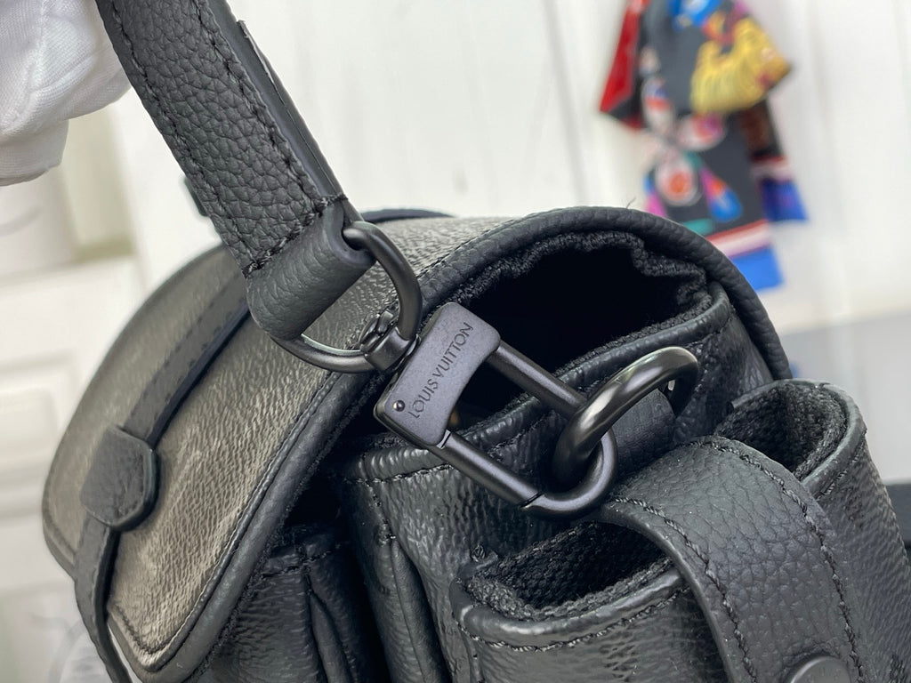 Louis Vuitton black bag close-up of strap rings and metal O-ring attachment