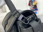 Louis Vuitton black bag close-up of strap rings and metal O-ring attachment