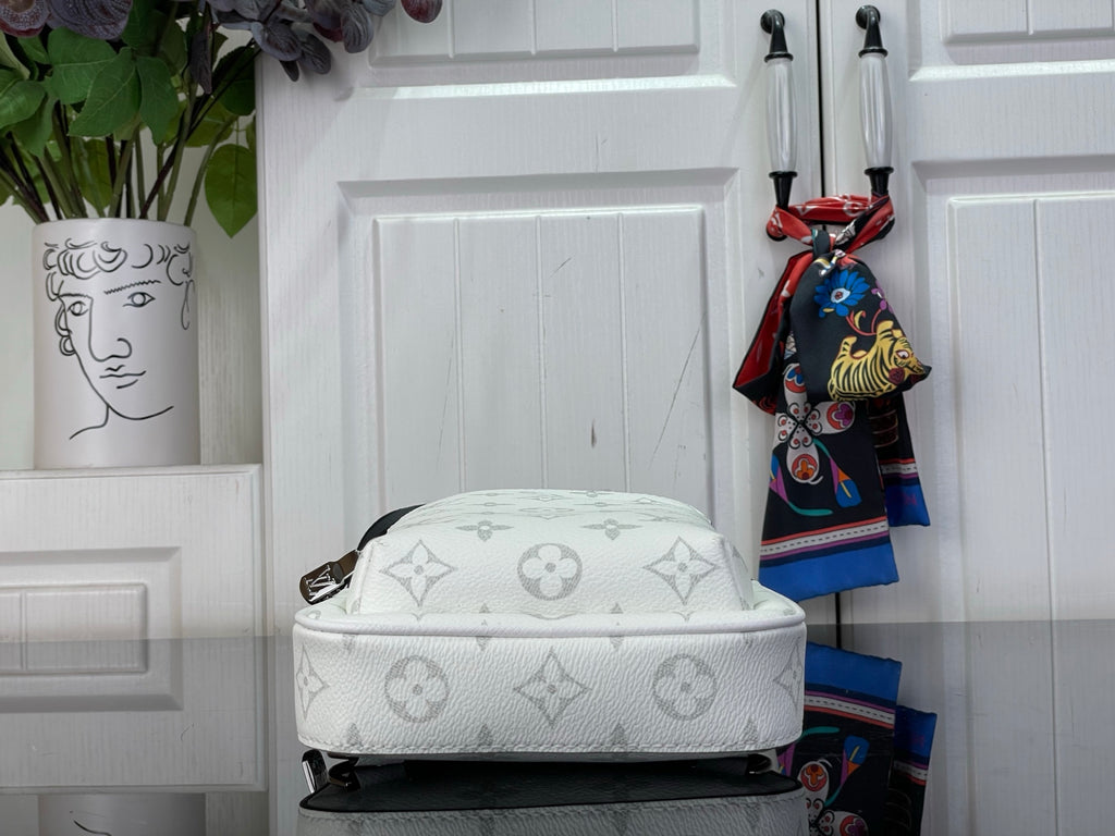 White Louis Vuitton monogram crossbody bag with curved top and visible zipper track