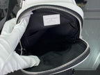 Open white Louis Vuitton monogram bag showing black fabric interior lining