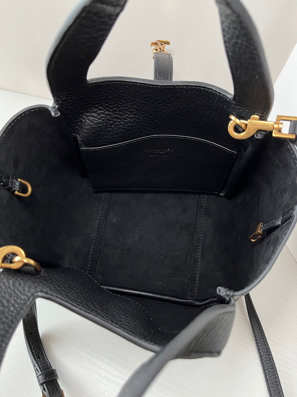 YSL leather mini tote bag interior view, black lining with side pockets and hardware.