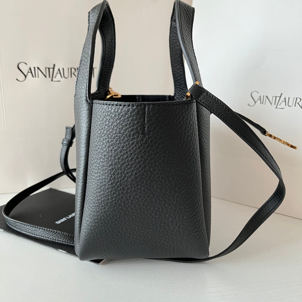 YSL leather mini tote bag with adjustable strap, black exterior and gold-tone hardware.