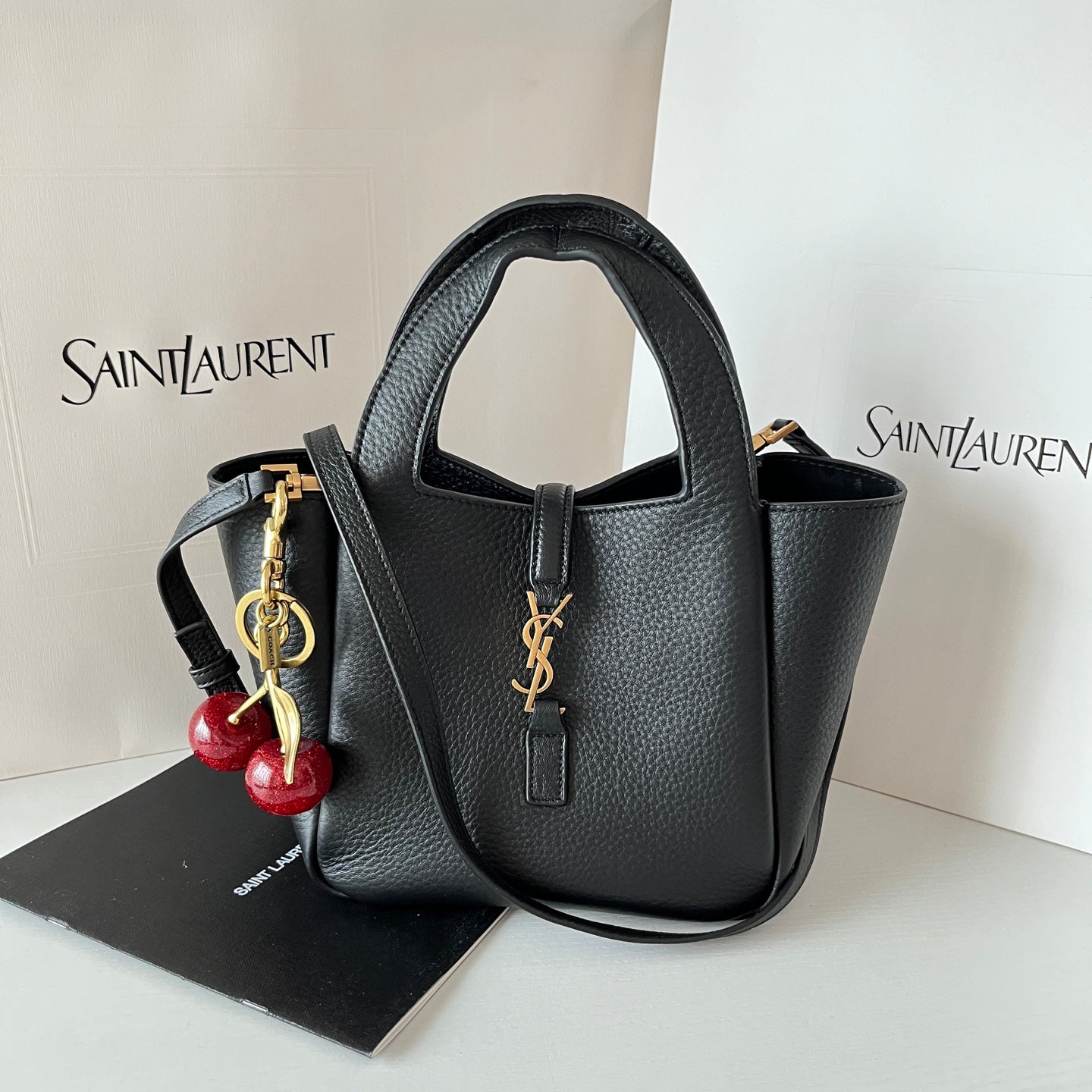 YSL leather mini tote bag, black with top handles and gold-tone YSL clasp.