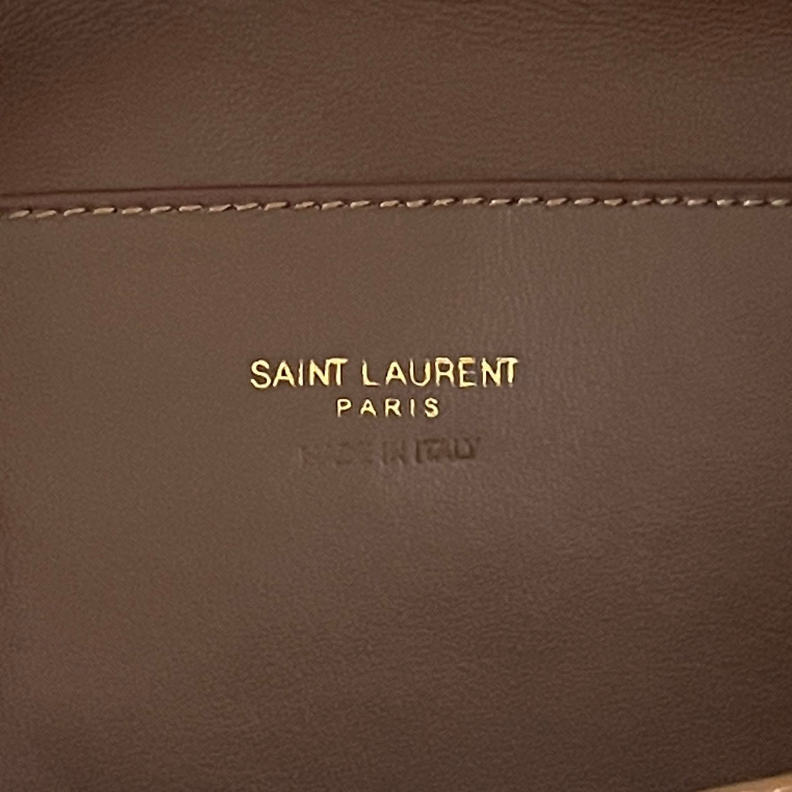YSL brown leather patch with Saint Laurent Paris logo text and stitching