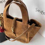 YSL tan suede mini tote front close-up with YSL logo charm on the pocket