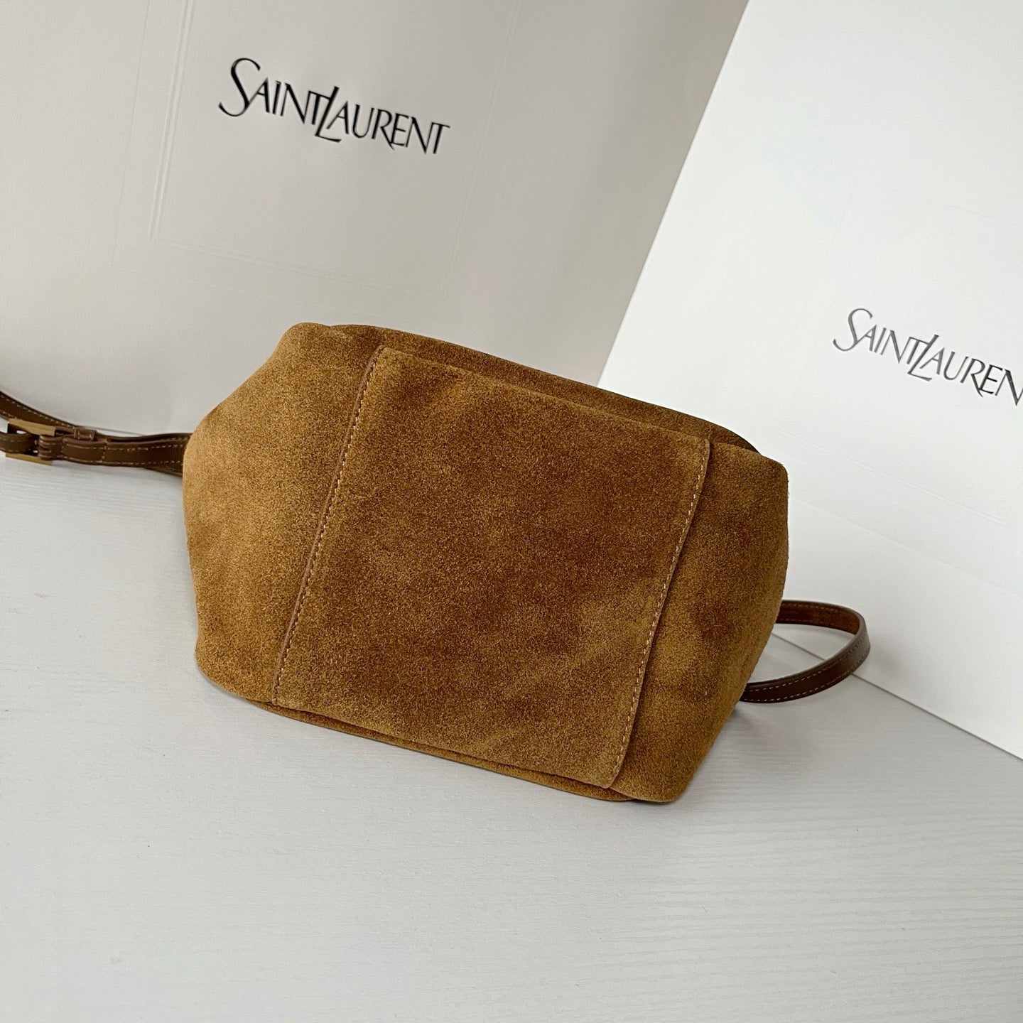 YSL tan suede crossbody pouch with flap front panel and long shoulder strap
