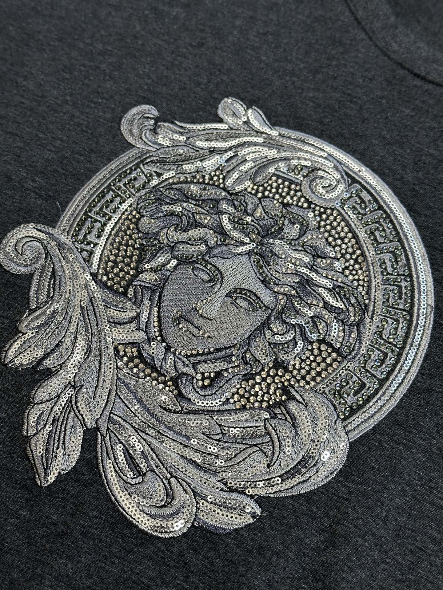 Versace Medusa-inspired front graphic on dark heather gray T-shirt, sequin-style detail
