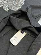 Versace T-shirt inside neck and care labels on dark heather gray fabric