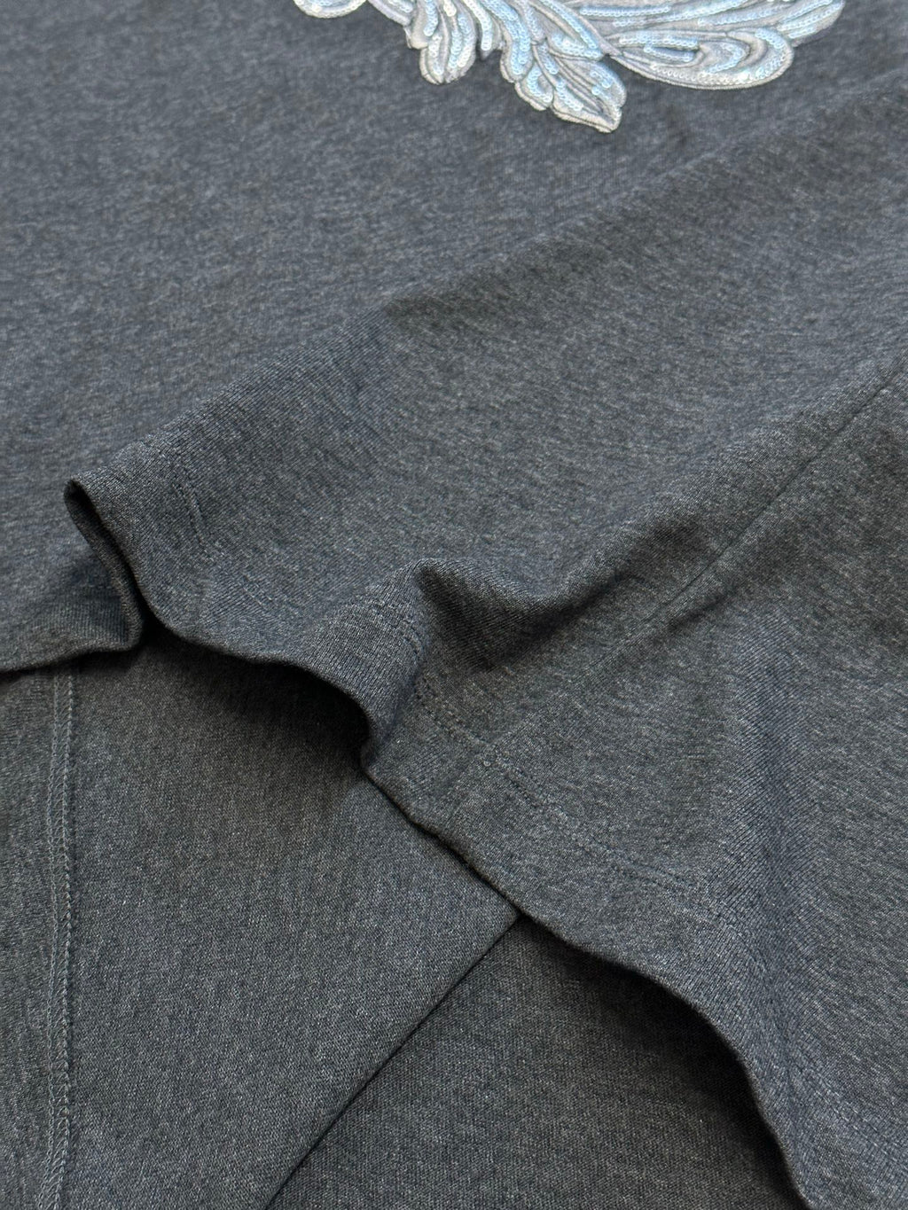 Versace T-shirt fabric close-up, dark heather gray jersey with soft drape