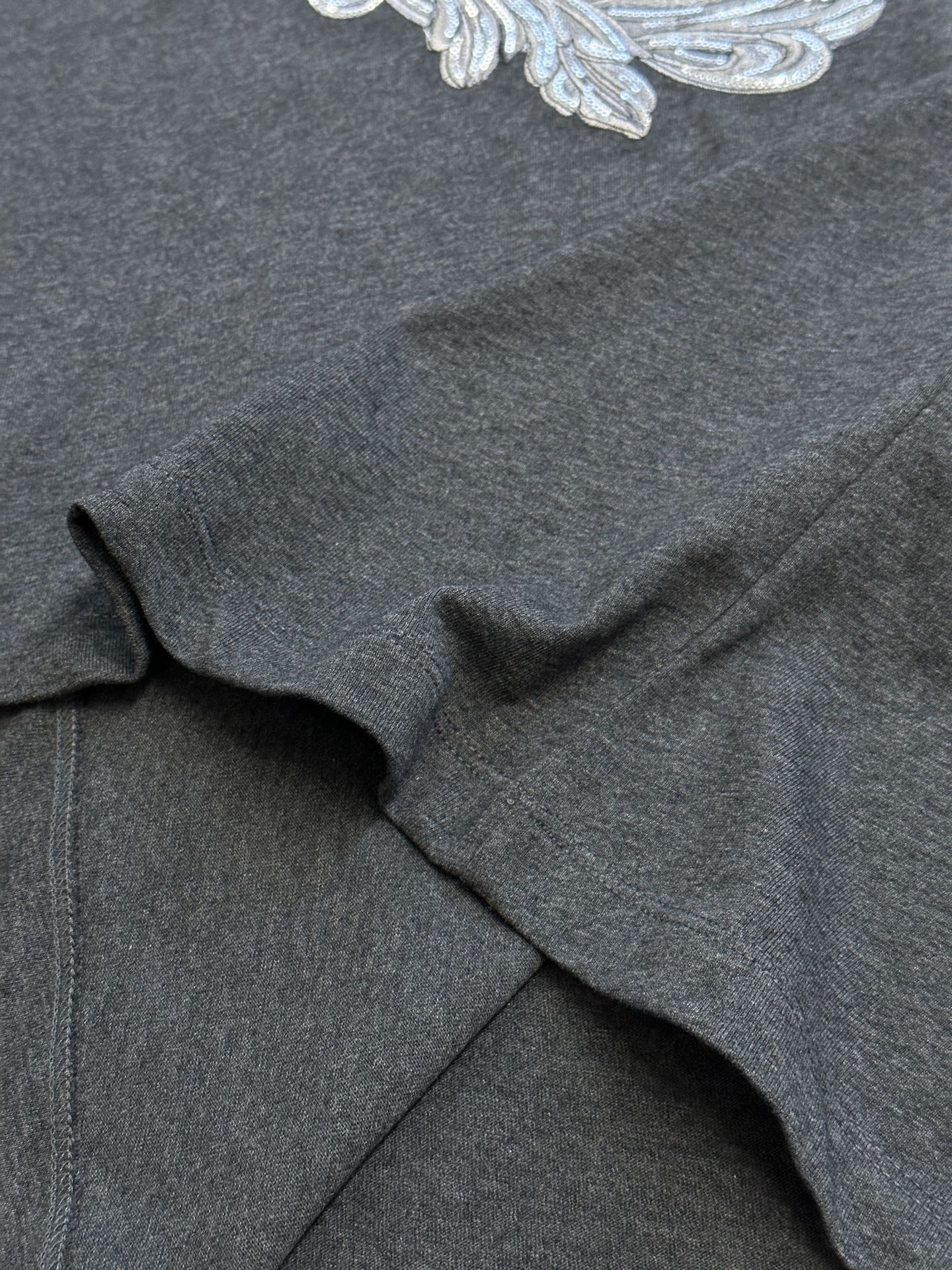 Versace T-shirt fabric close-up, dark heather gray jersey with soft drape
