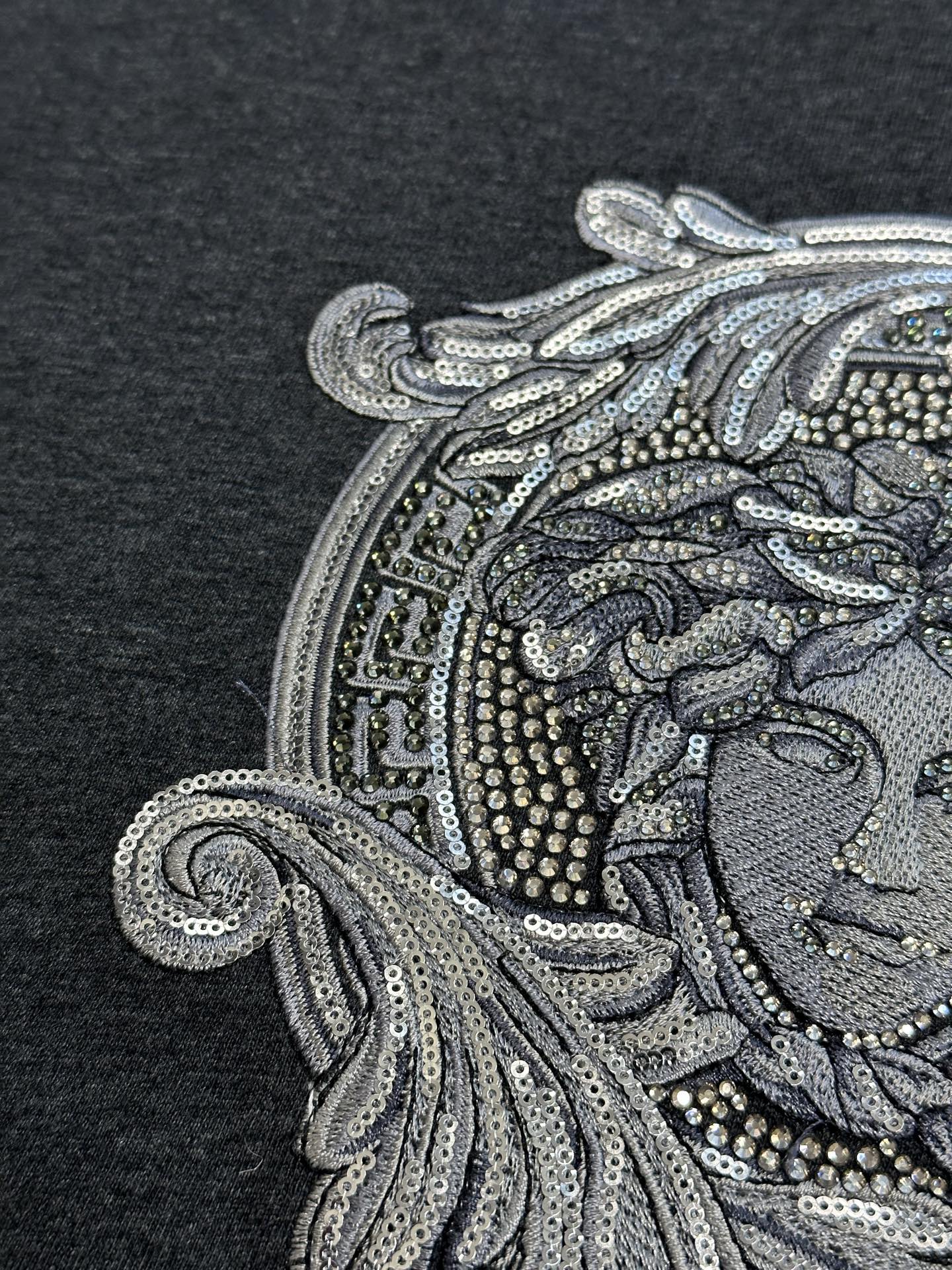 Versace Medusa front graphic close-up with bead and sequin-style detailing
