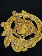 Versace black T-shirt close-up of gold Medusa head embroidery