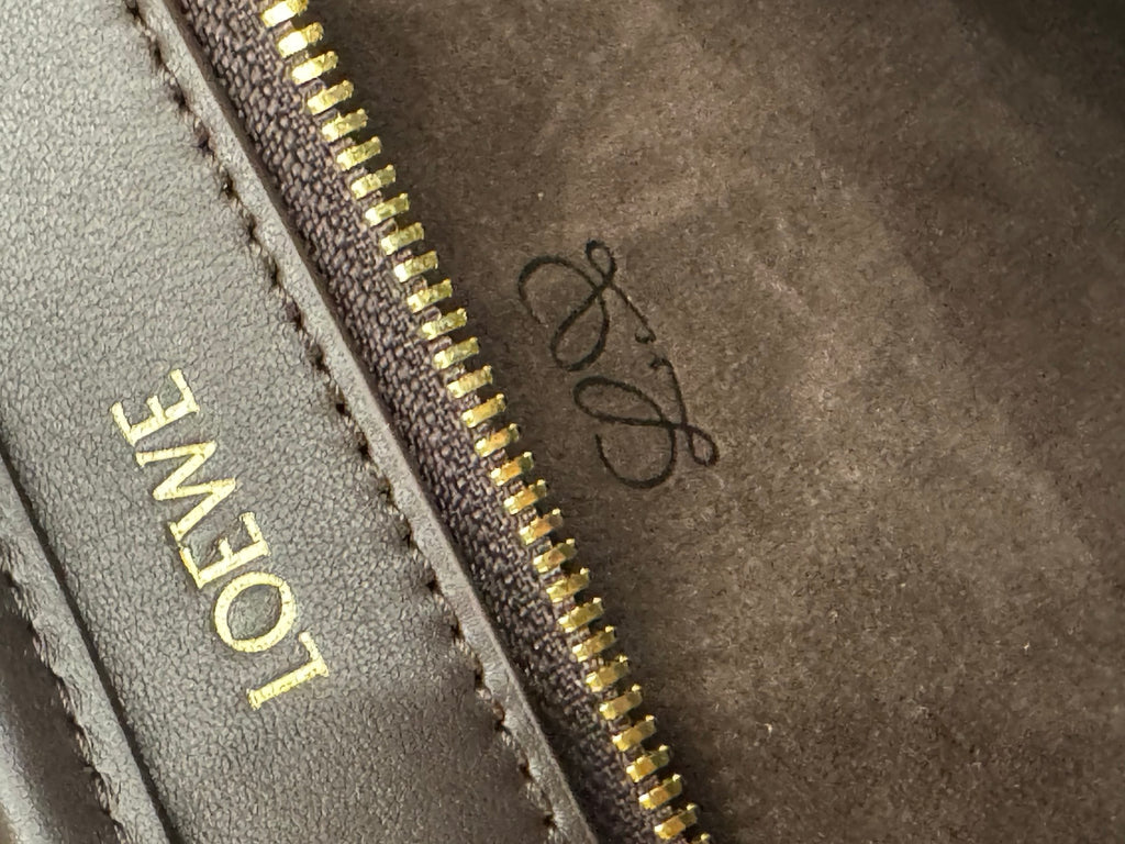 Gold zipper and embroidered Loewe logo on suede interior