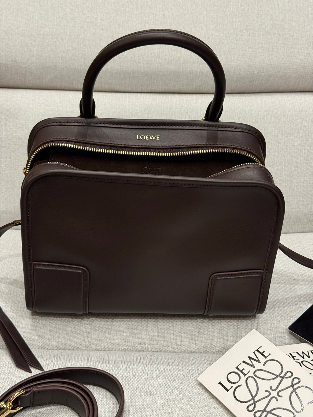 Dark brown leather Loewe top-handle bag with front pockets and gold zipper