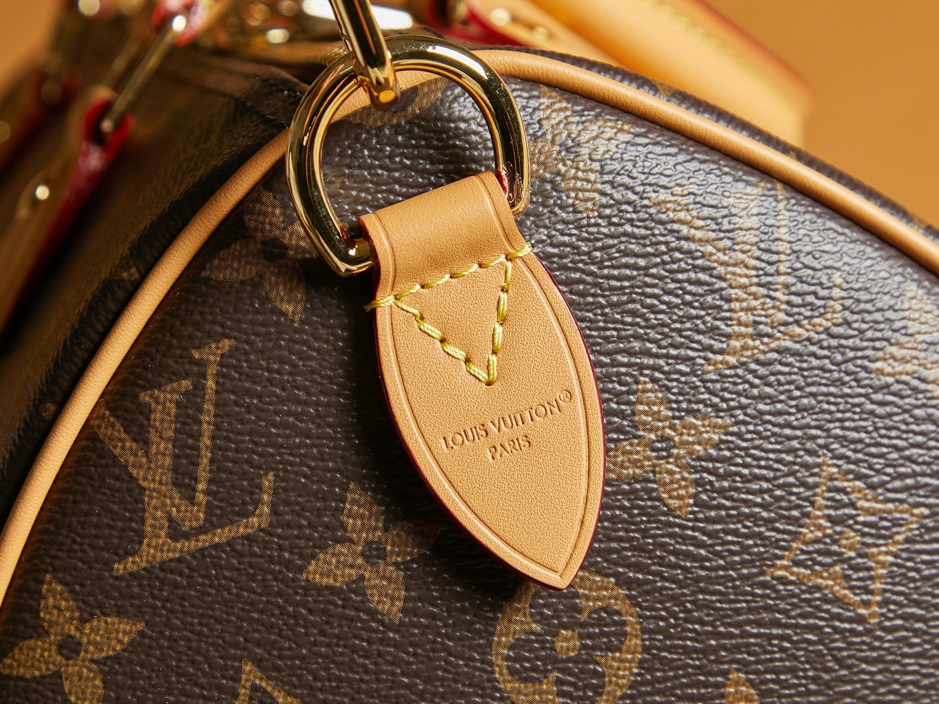 Louis Vuitton monogram bag leather key fob with gold-toned clasp