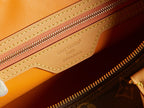 Louis Vuitton monogram bag interior zipper label on brown leather trim
