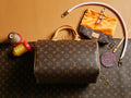 Louis Vuitton monogram handbag with top handles and wristlet strap