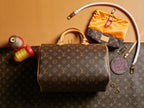 Louis Vuitton monogram handbag with top handles and wristlet strap