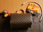 Louis Vuitton monogram handbag with top handles and zipper hardware