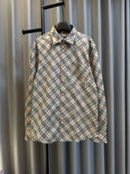 Burberry plaid button-up shirt with pointed collar, long sleeves, chest pocket