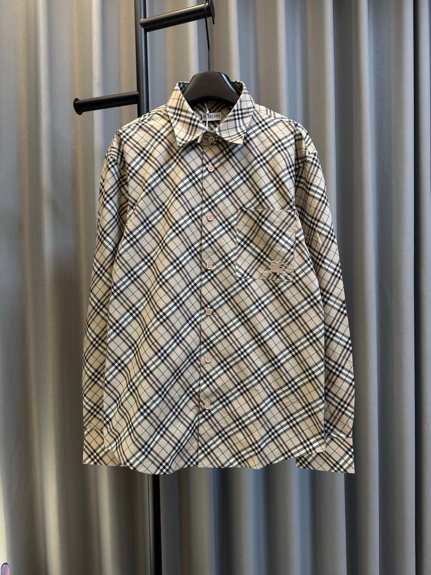 Burberry plaid button-up shirt with dark button front and pointed collar