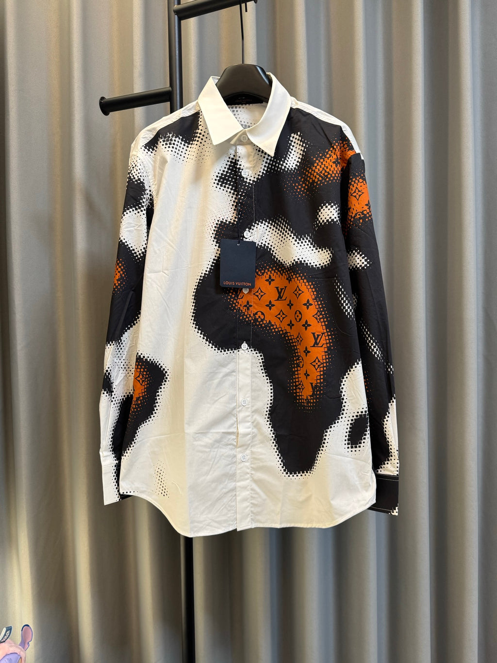 Louis Vuitton long-sleeve shirt in black, white, and orange camo print, button front