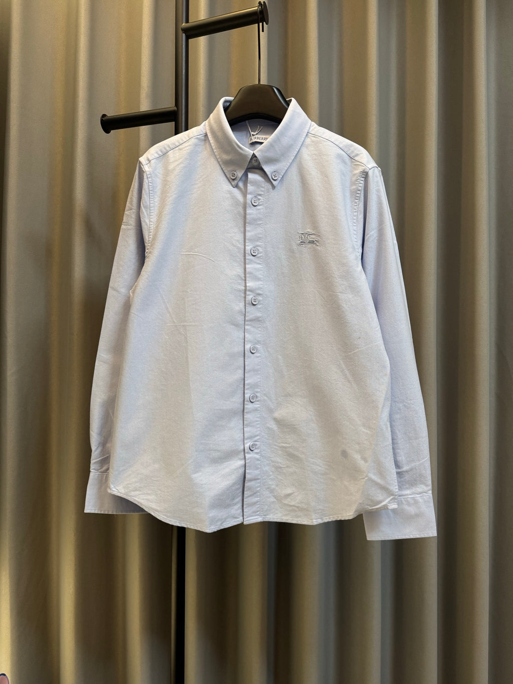 Light blue Burberry button-up shirt with pointed collar and small chest logo
