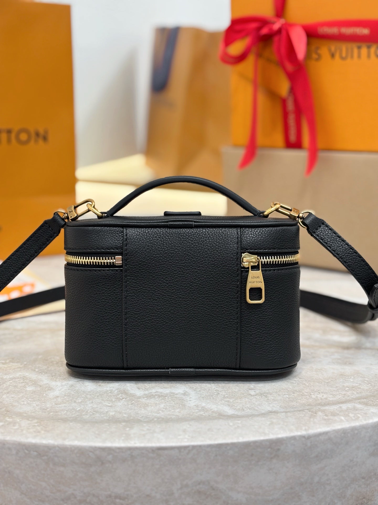 Louis Vuitton top-handle bag in dark black with shoulder strap and gold zipper detail