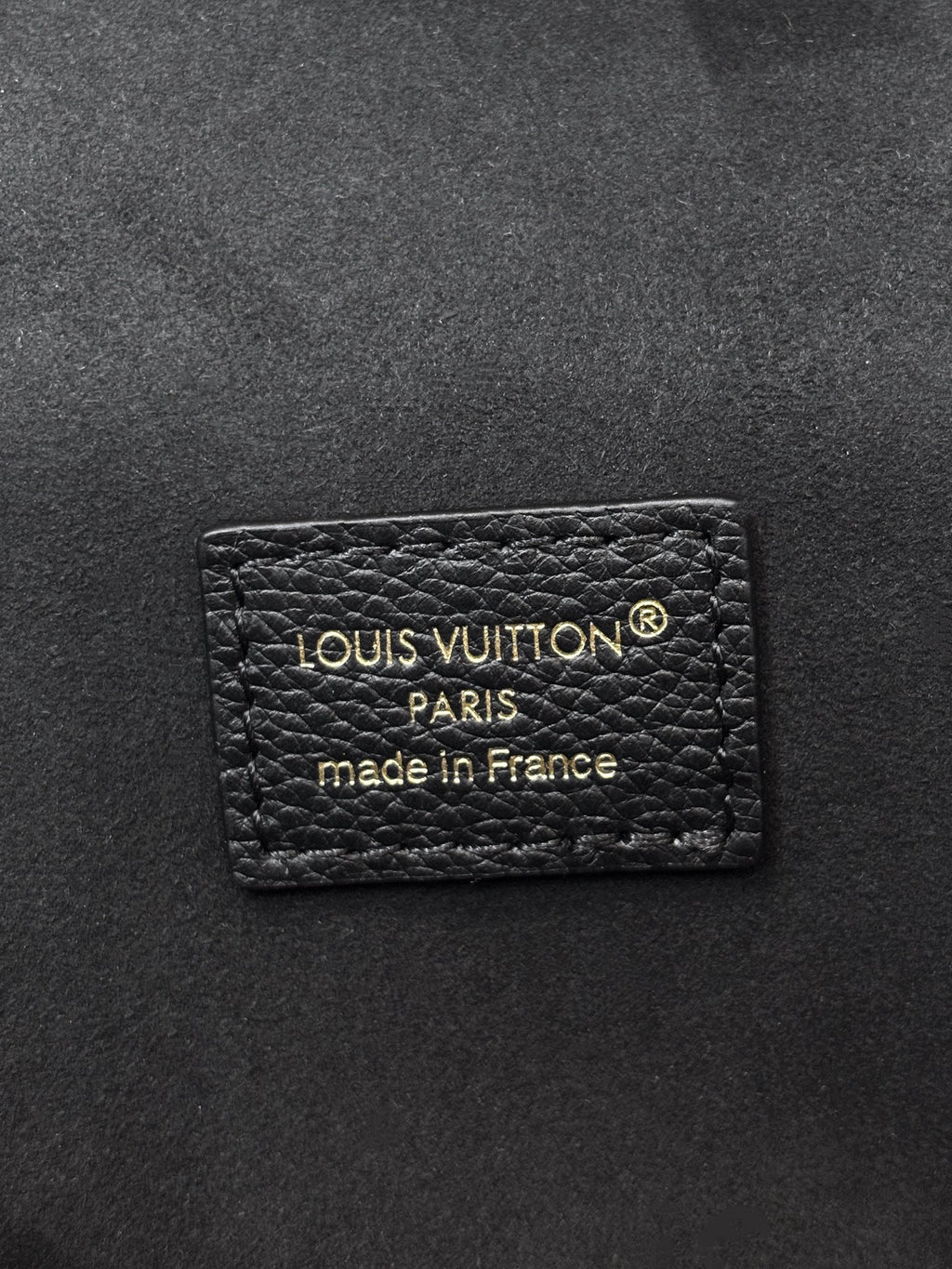 Louis Vuitton Paris label on dark black leather, made in France