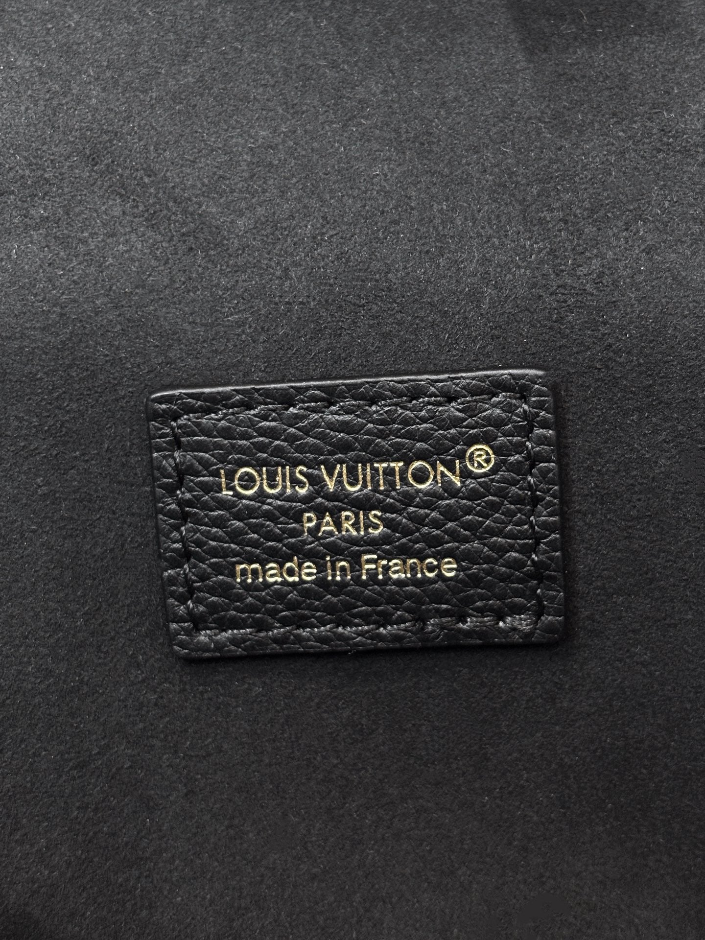 Louis Vuitton Paris label on dark black leather, made in France