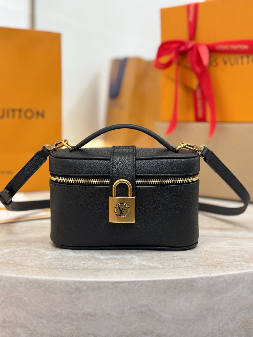 Louis Vuitton top-handle bag in dark black with gold zipper and front lock hardware
