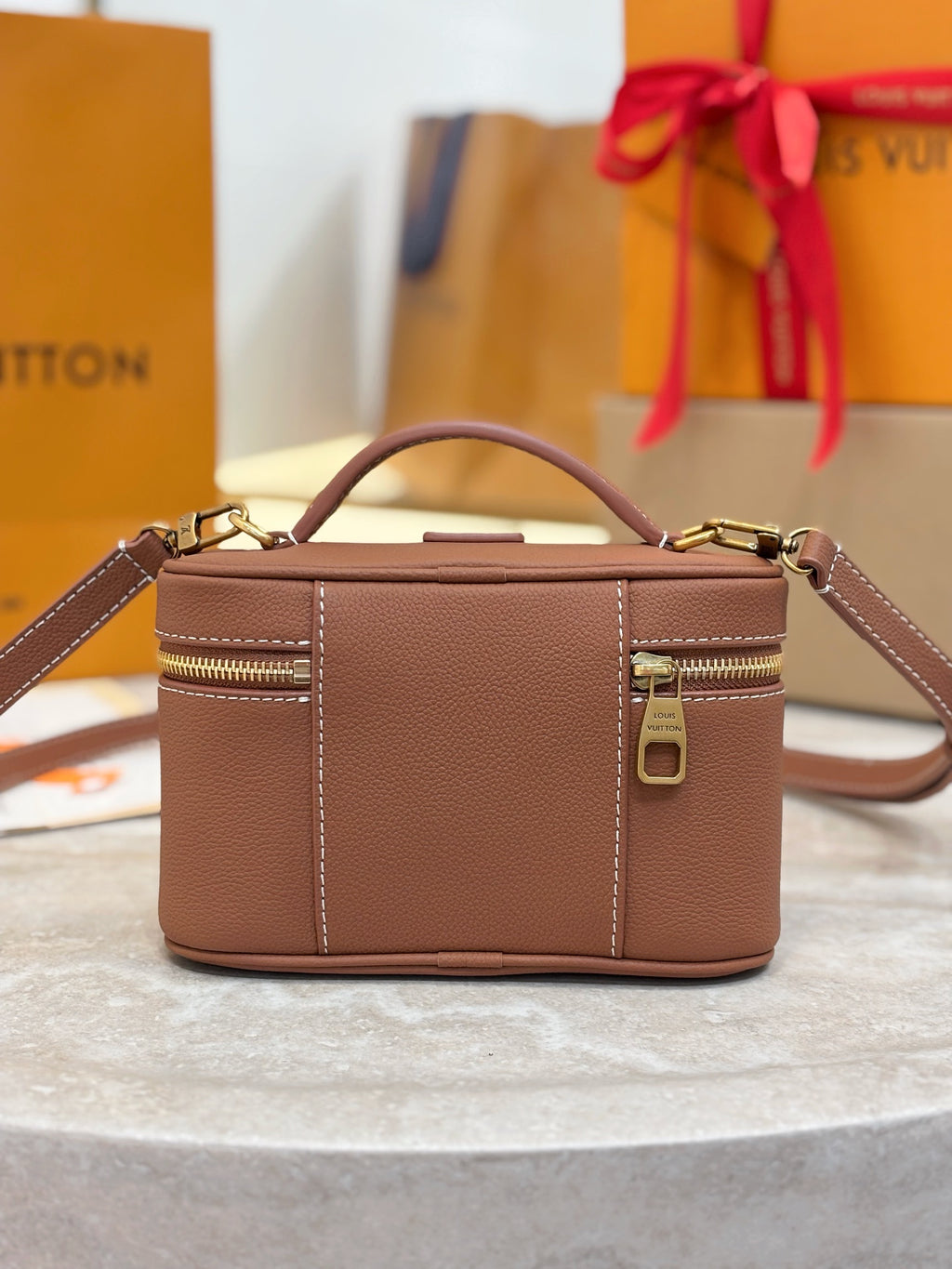 Louis Vuitton top-handle bag in brown leather with side zipper detail and front panel seam
