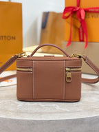 Louis Vuitton top-handle bag in brown leather with side zipper detail and front panel seam