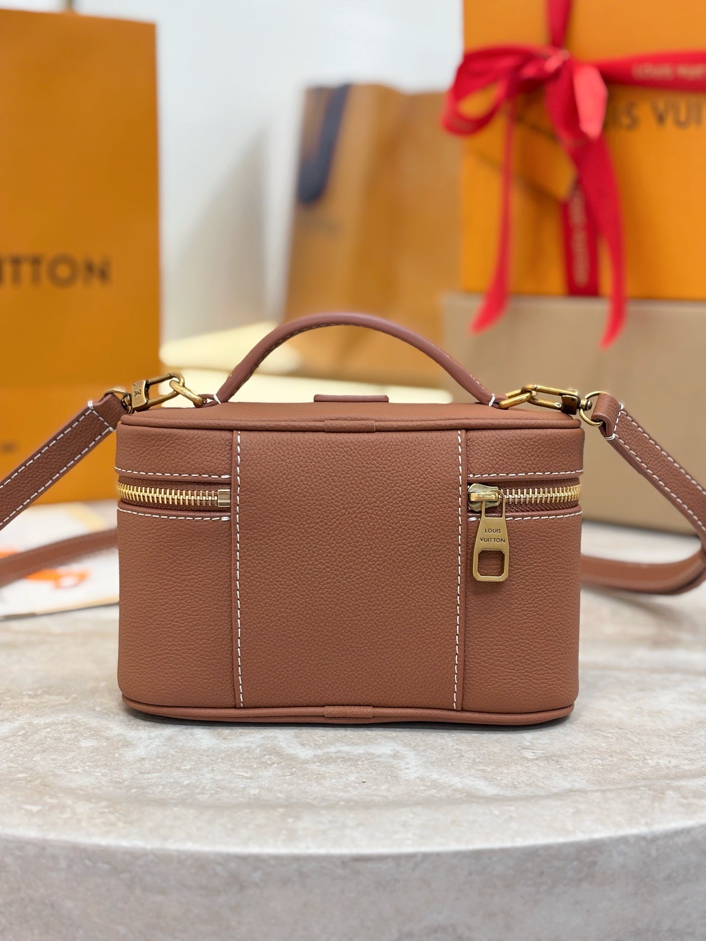 Louis Vuitton top-handle bag in brown leather with side zipper detail and front panel seam