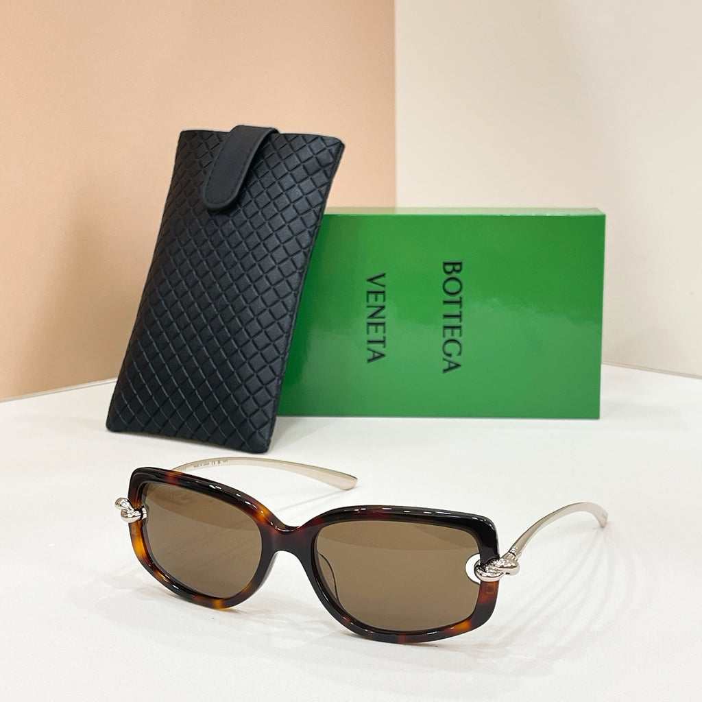 Tortoiseshell sunglasses with dark lenses and metal arms, with a black textured case