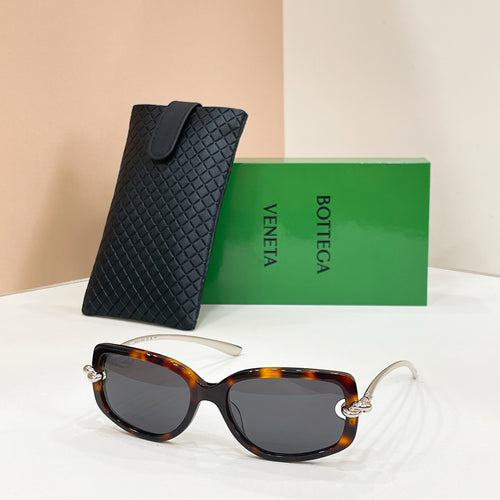 Tortoiseshell sunglasses with dark lenses and metal arms, paired with a black case