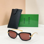 Bottega Veneta sunglasses, black frames with reddish-brown lenses and gold hardware