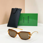 Bottega Veneta sunglasses, amber frames with dark lenses and gold-tone hardware