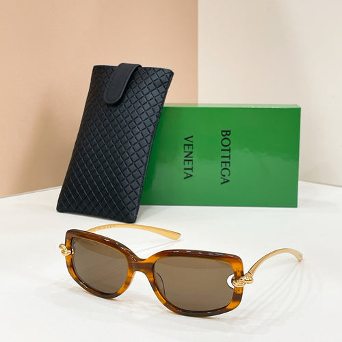 Bottega Veneta sunglasses, amber frames with dark lenses and gold-tone hardware