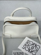 White leather handbag with top handle, open top, and interior logo patch