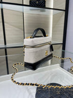 Chanel bag in light gray/white with gold chain strap, small top handle, black trim