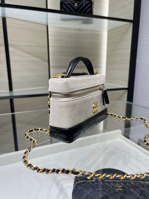 Chanel bag in light gray/white with gold chain strap, small top handle, black trim