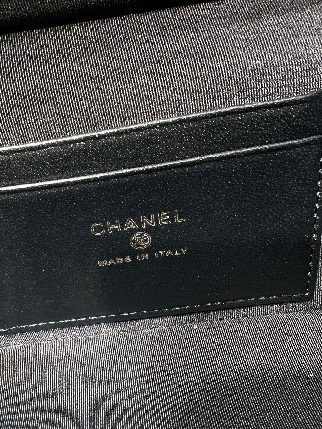 Chanel bag lining label on black fabric showing CHANEL and Made in Italy