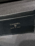 Chanel bag lining label on black fabric showing CHANEL and Made in Italy