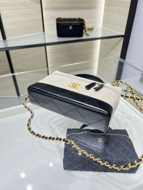 Chanel bag with light gray flap and black body, gold chain strap and hardware