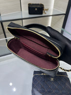 Chanel mini handbag open view, black exterior and burgundy interior, zip top