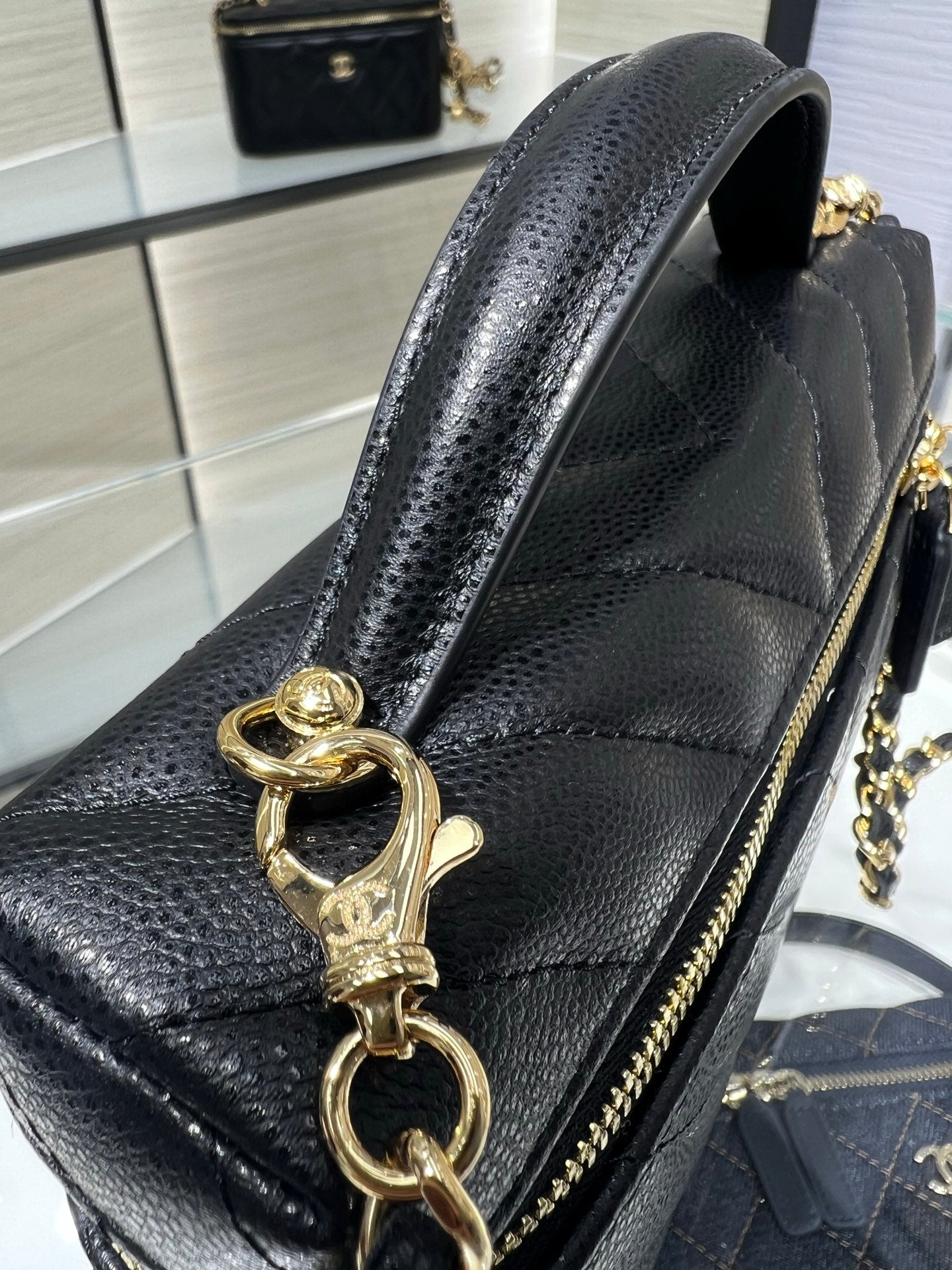 Chanel leather mini bag with gold chain and lobster clasp, black textured finish