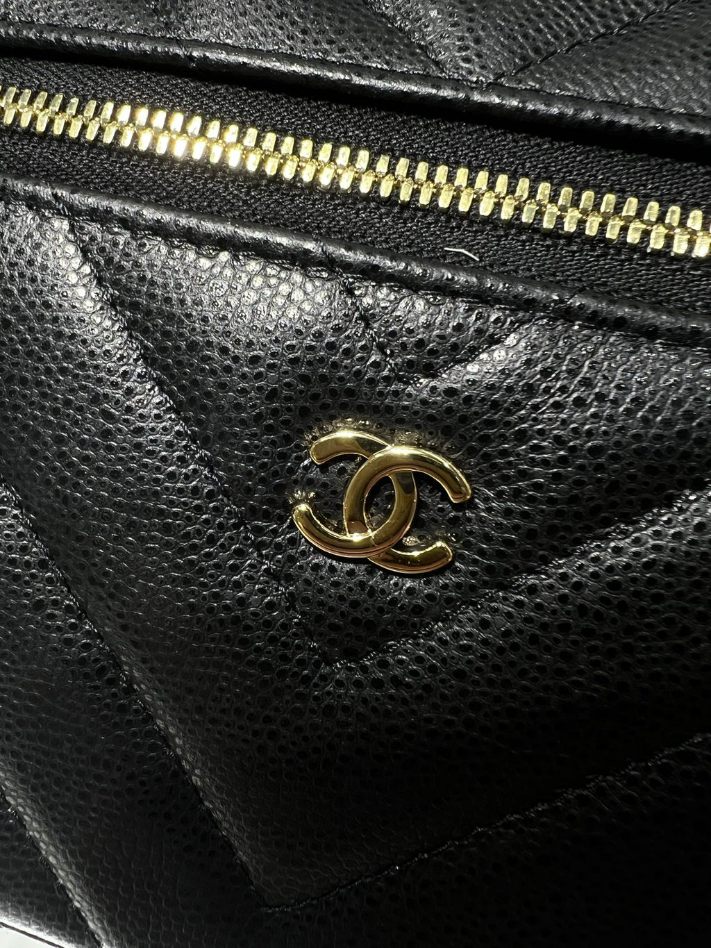 Chanel logo turn-lock clasp on black quilted leather bag, gold-tone hardware