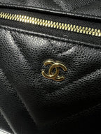 Chanel logo turn-lock clasp on black quilted leather bag, gold-tone hardware