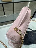 Pink leather shoulder bag with gold chain and heart-shaped key charm
